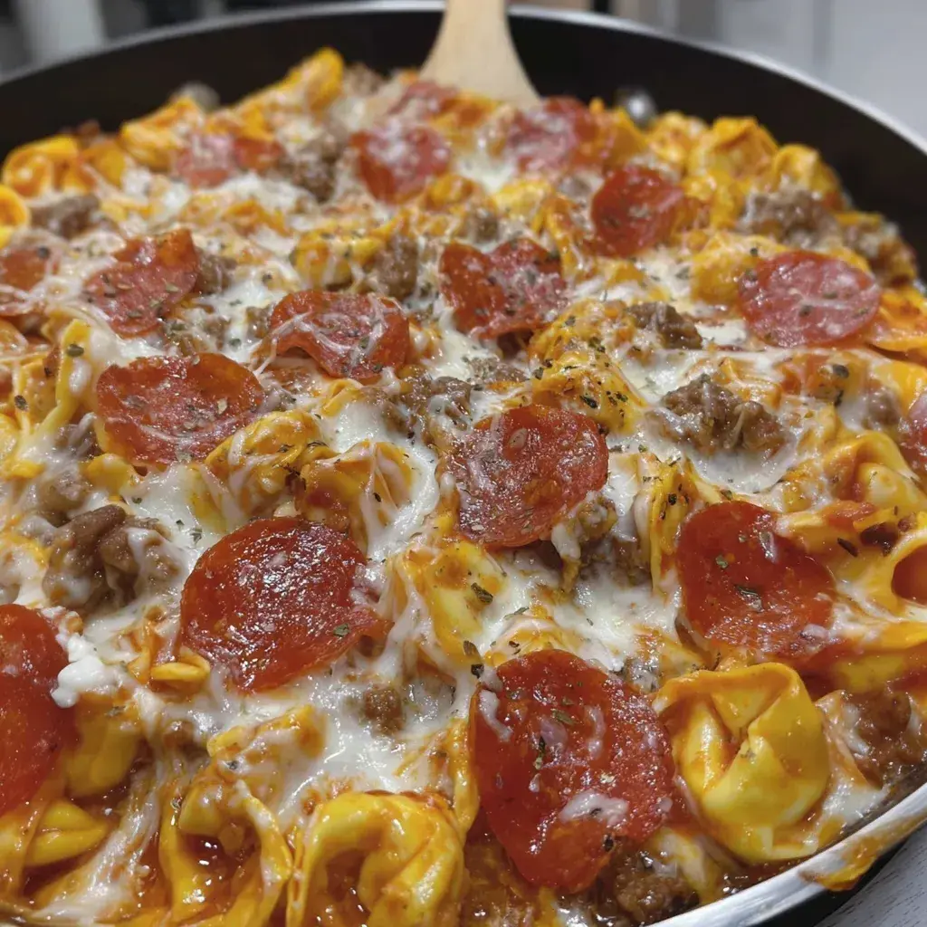Finished Pizza Tortellini Skillet dish in a skillet, topped with melted cheese and pepperoni, ready to serve.
