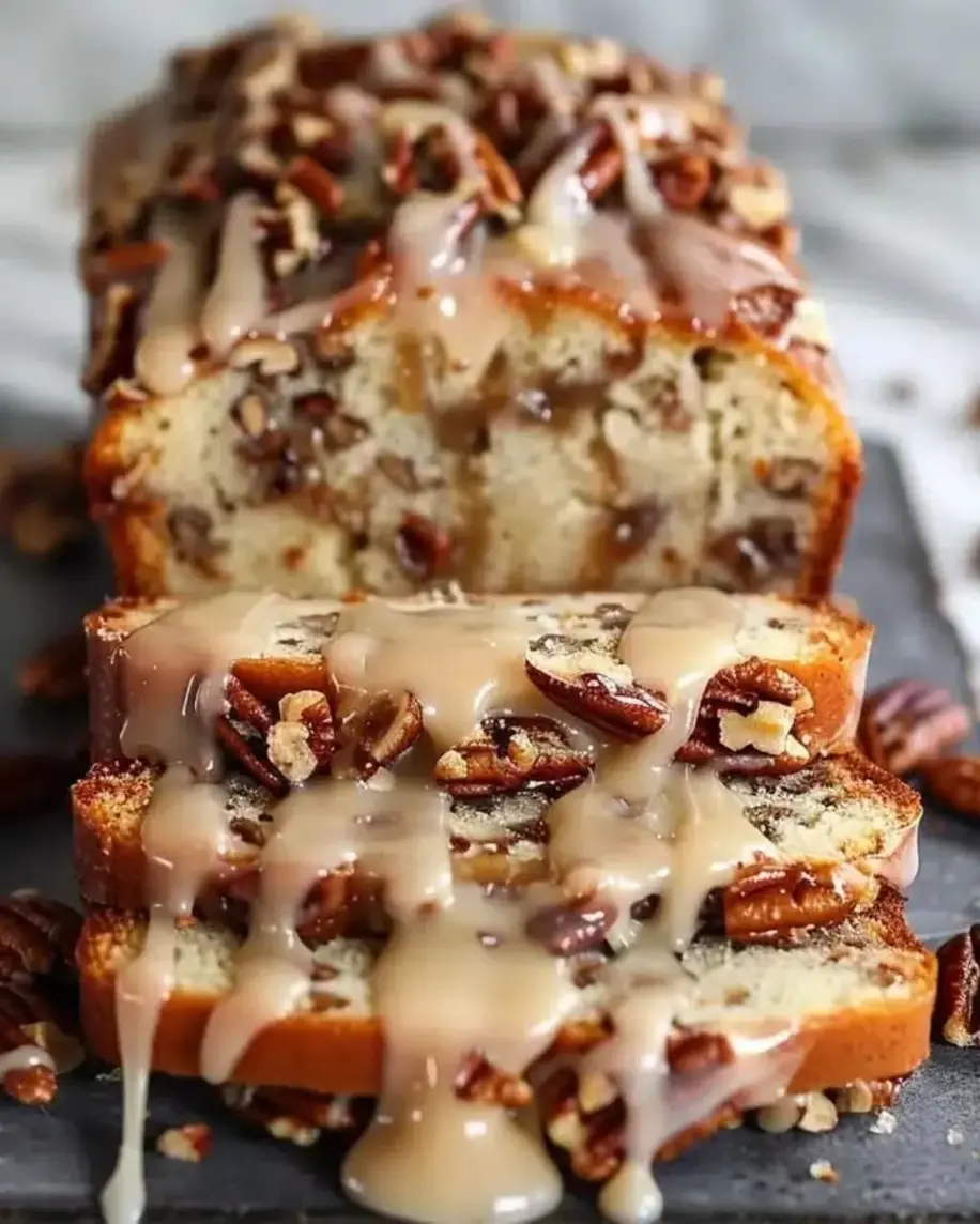 A close-up of the Pecan Praline Buttermilk Loaf Cake, showcasing the crunchy praline topping and moist interior.