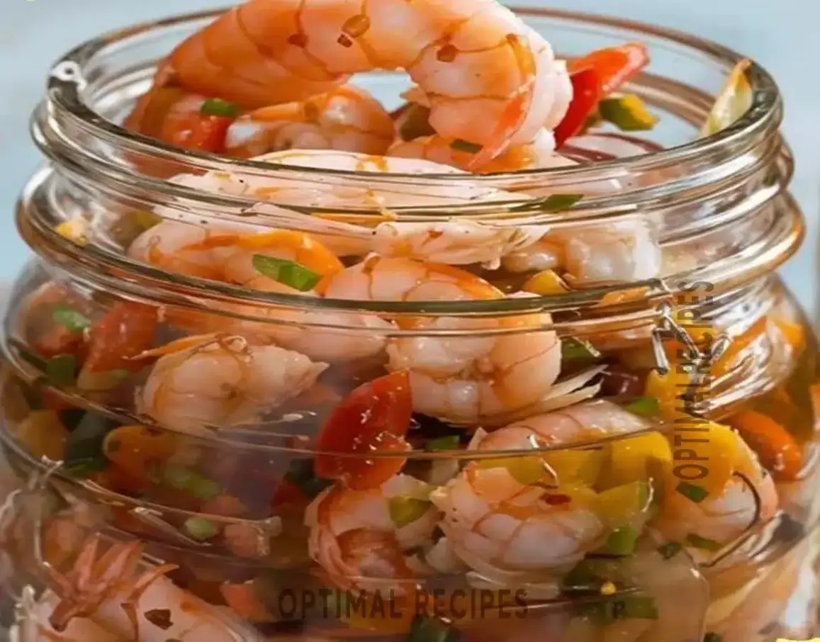 Finished homemade pickled shrimp dish, ready for serving with fresh garnishes