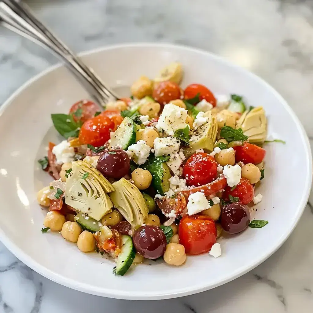 Finished Greek-style bean salad served in a bowl with garnishes