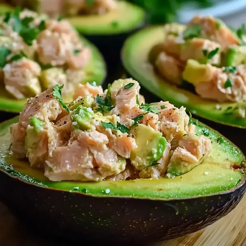 Assembled Tuna Avocado Boats on a plate, ready to serve with garnishes.