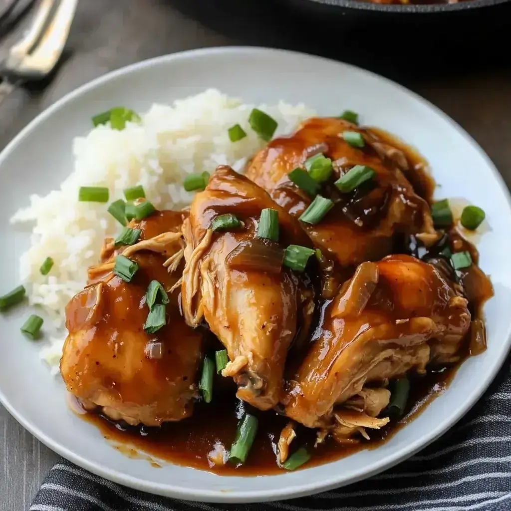 Crockpot Bourbon Chicken ingredients laid out on a kitchen counter with bourbon bottle and spices